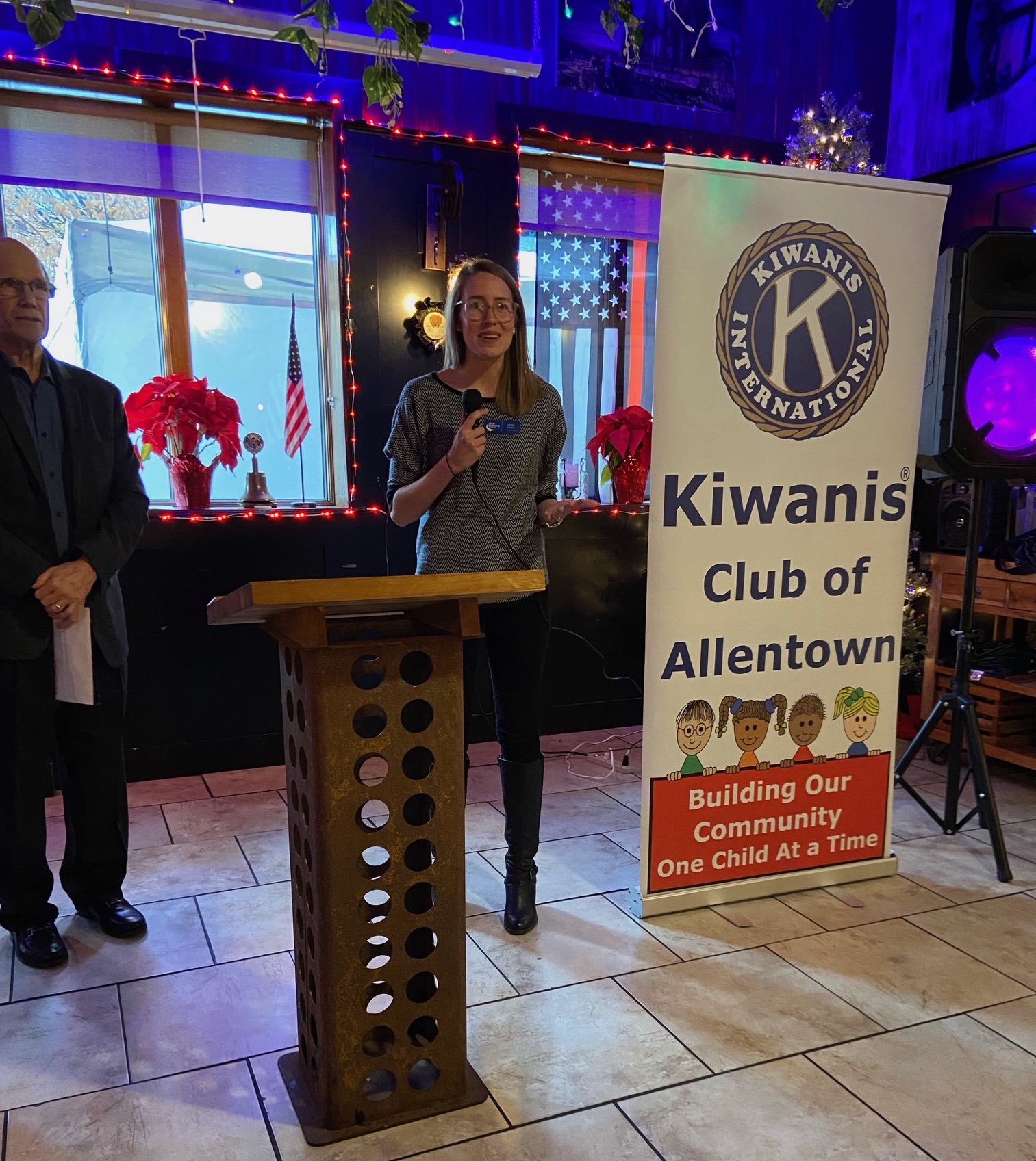 Speaker stands behind podium that reads "Kiwanis Club of Allentown"