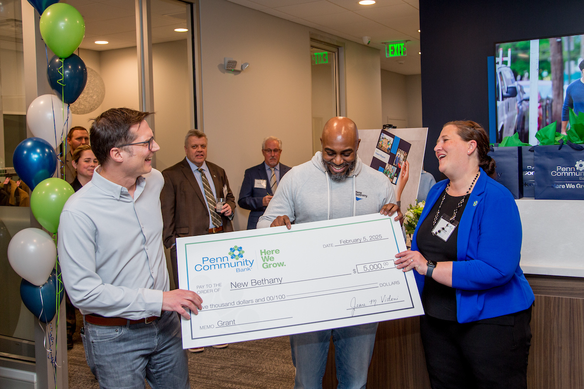 Marc Rittle Ellen Dodel and Isaiah Price holding the donation check