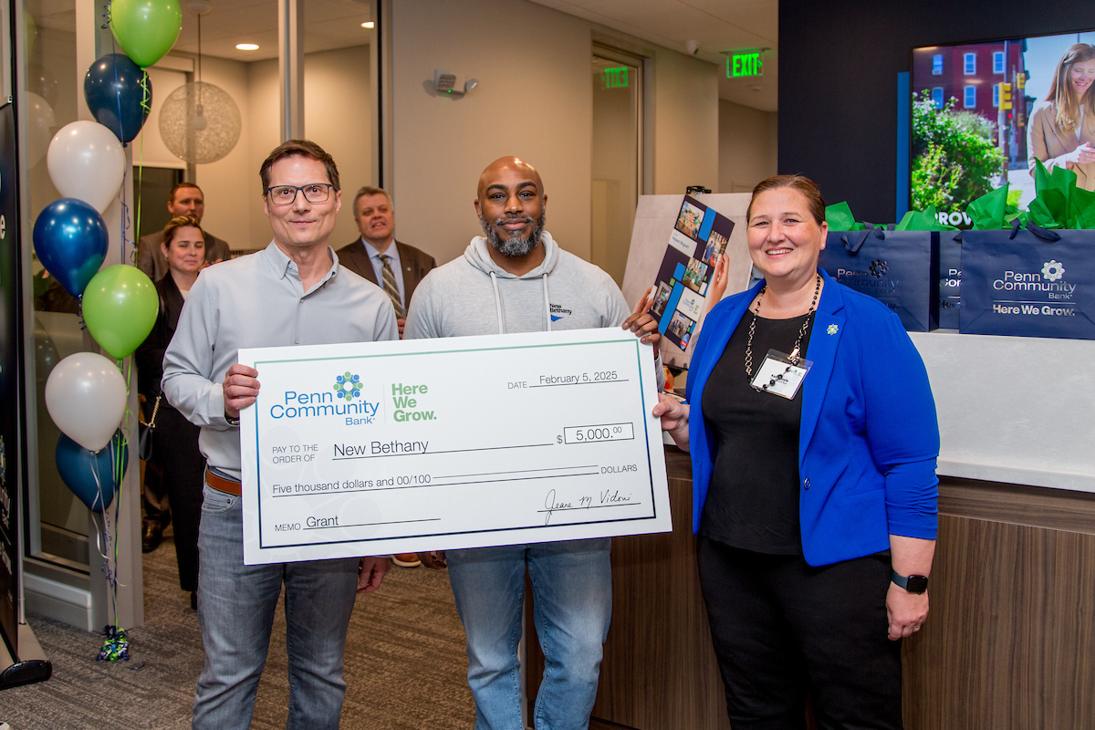 Marc Rittle Ellen Dodel and Isaiah Price holding the donation check