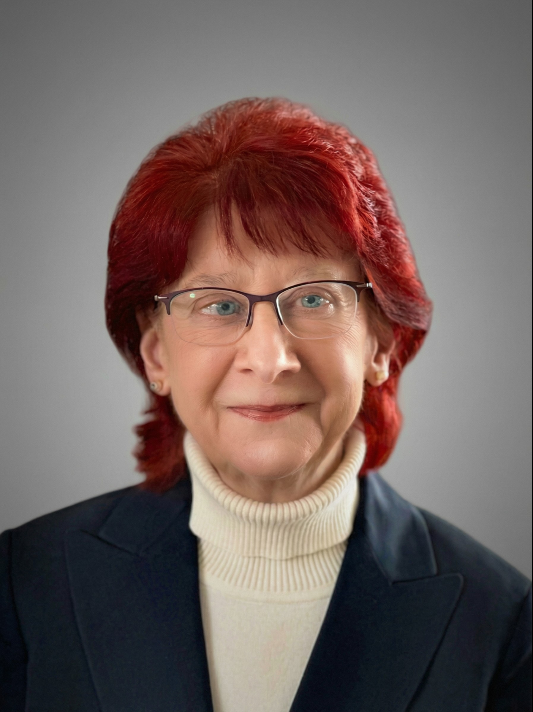 Woman with red hair smiling.